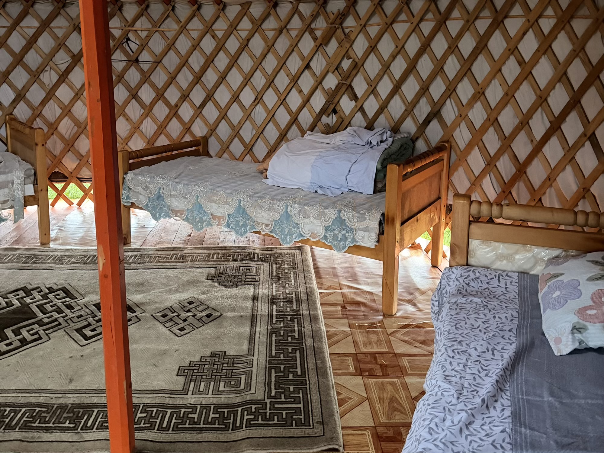 Losol fresh mare milk camp: Inside the ger: thick felt insulation, layered carpets, and a central wood stove designed to heat the entire space up in minutes. (Interior, Bedding, Decor)