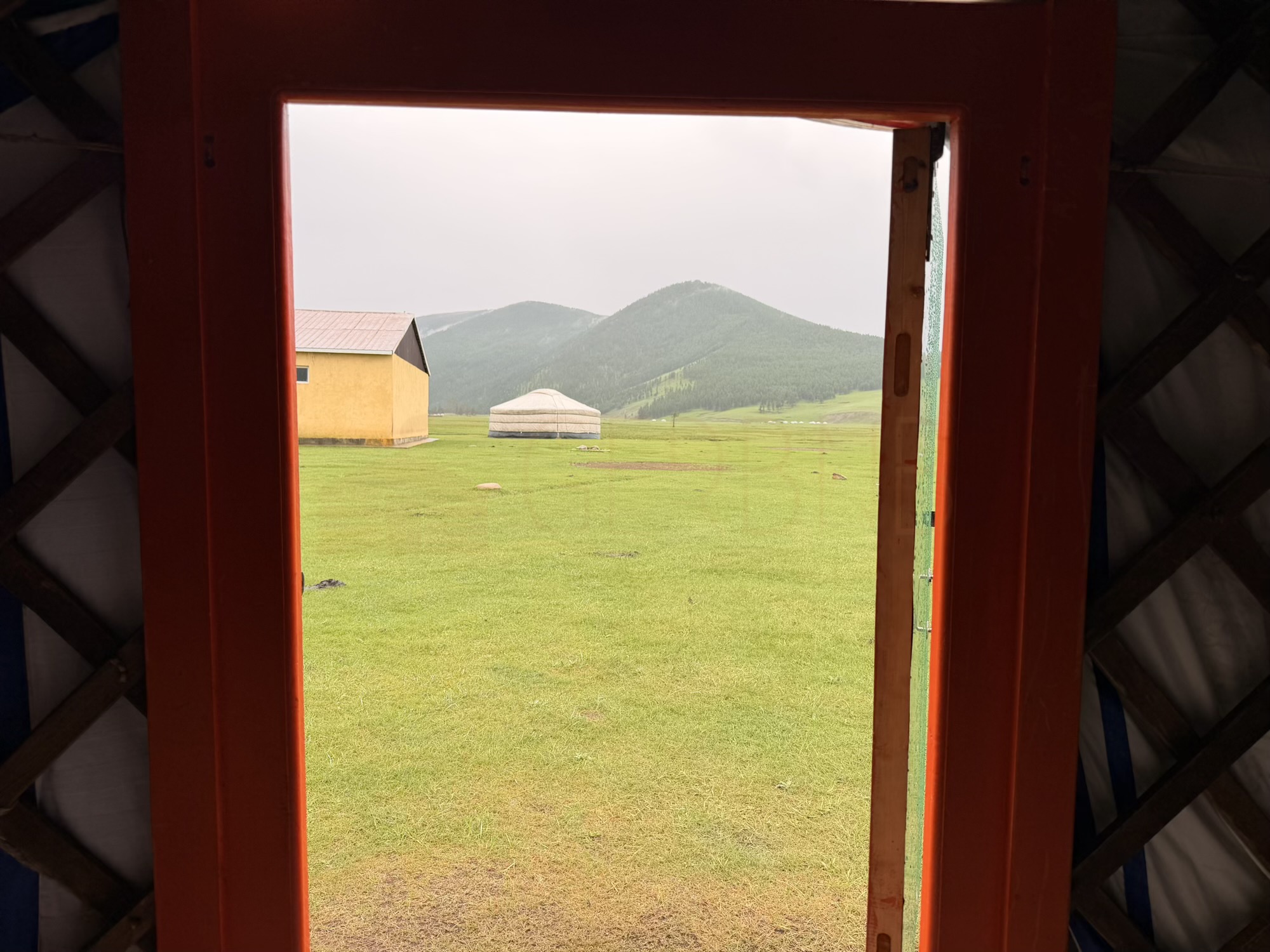 Bayrmaa Orkhon Waterfall camp: The doorway opens onto a valley framed by high, triangular mountains — a spot the family also uses for winter stays. (Valley view)