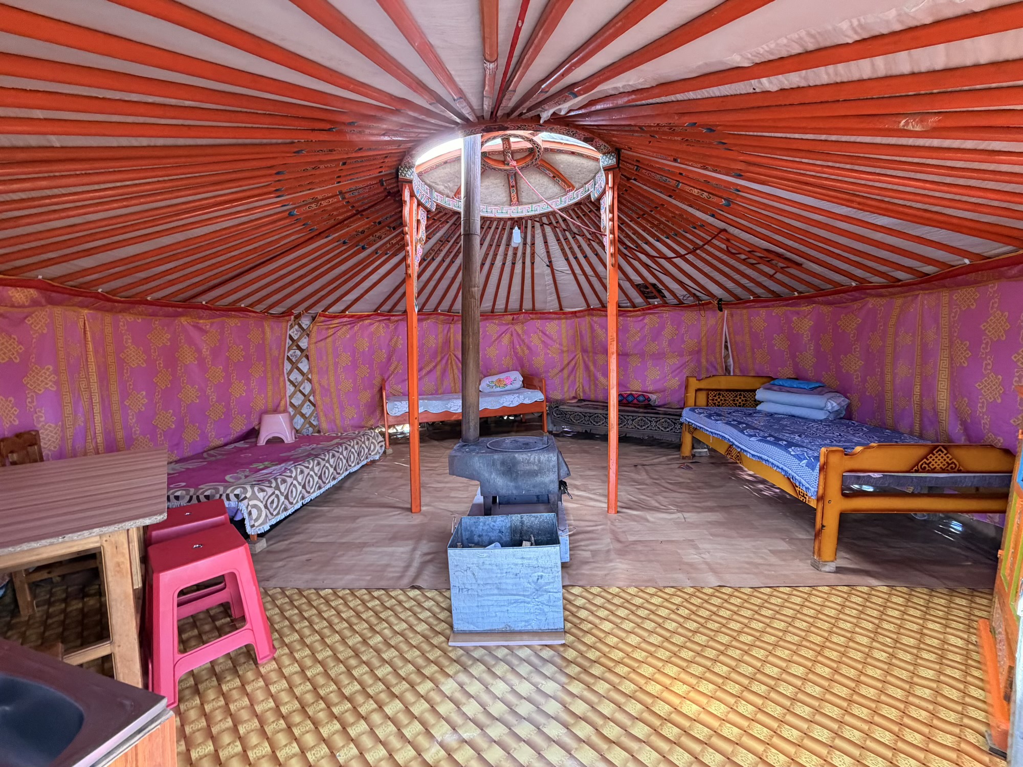 Gavalmaa volcano camp: We operate a spacious guest ger equipped with comfortable beds and a central heating stove, providing plenty of room for families to relax. (Interior, Bedding, Ger Layout)